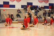 Freshman Sara Wang (back line), sophomore Katie Zhang (back middle line), junior Melody Chiang (front middle line), sophomore Sahana Aiyer (back line), senior Jennifer Song (front line), senior Andrea Tse (front middle line), sophomore Rae Moar (back line) and sophomore Katherine Barbano (back middle line) lift their toes to the sky as they do a leg hold.