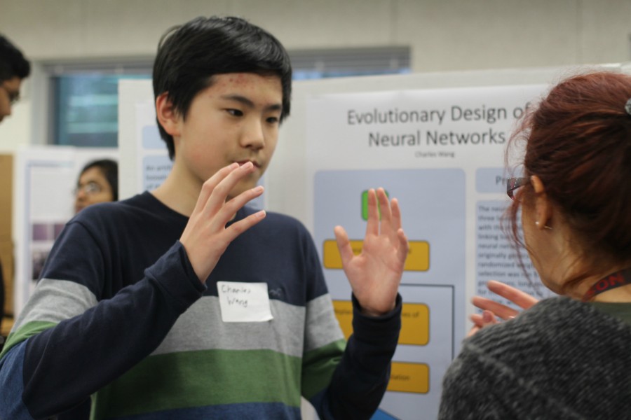 Sophomore+Charles+Wang+explains+his+science+fair+project+to+biology+teacher%2C+Dr.+Del+Cerro.