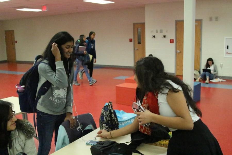 Active Minds's "Random Acts of Kindness" on Feb. 25 involved students giving out Hershey kisses throughout the school. Sophomore Nira Harikrishnan is working with Active Minds to help spread joy and pass out these chocolate kisses to students like sophomore Nikita Sivakumar.