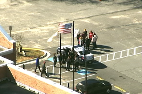 Police officers and school officials convene at McLean High School following a bomb threat on Feb. 29. According to police, this threat is not connected to the threats made later that week, on March 4.