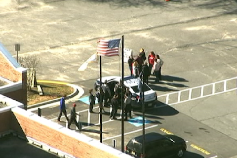 Police officers and school officials convene at McLean High School following a bomb threat on Feb. 29. According to police, this threat is not connected to the threats made later that week, on March 4. 