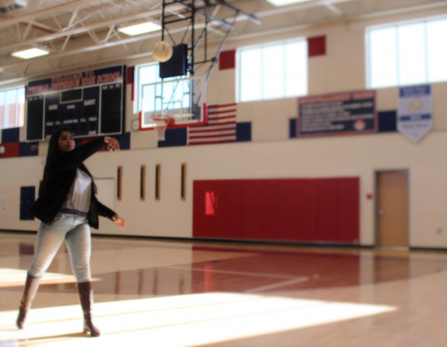 Practicing her throw, sophomore Sajana Challa prepares for spring softball.