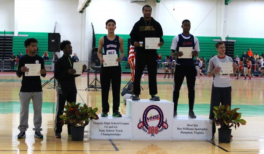 Senior Charlie Guan stands on the podium to receive his award. He placed second overall in the 55m hurdles, breaking his own Jefferson school record.