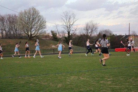 Freshman Manna Haile, defense, stands in front of Jeffersons goal against a Marshall player during the girls JV lacrosse game on March 17.