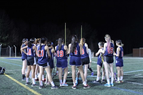 The varsity team huddles around Coach Alam to talk strategy during a time-out at South Lakes on March 12.