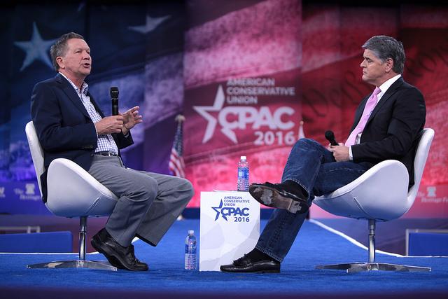Presidential candidate John Kasich speaks to political commentator Sean Hannity at the 2016 Conservative Political Action Conference (CPAC).