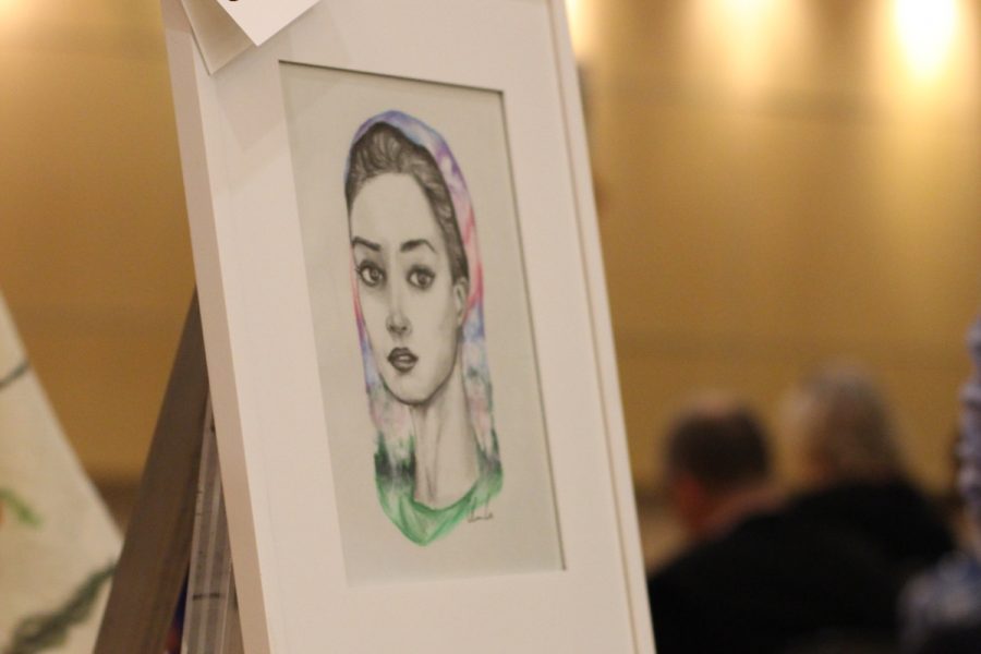 Sophomore Olivia Lu sells artwork at charity event