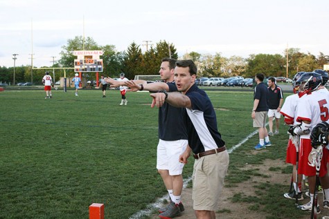 Head Coach Jackson Kibler coaches from the sidelines in a lacrosse game.  He has been the head coach for two seasons.