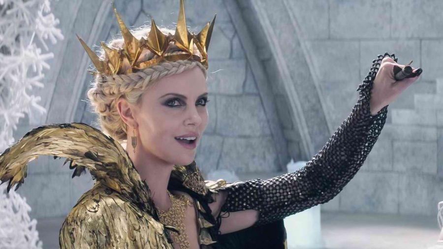 Charlize Theron, reprising her role as Ravenna, smirks as she catches a bolt.