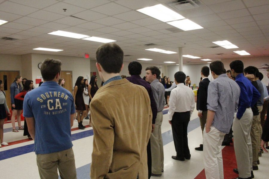 Students separate based on gender and stand on opposite sides of the commons as instructed by the dance teacher.