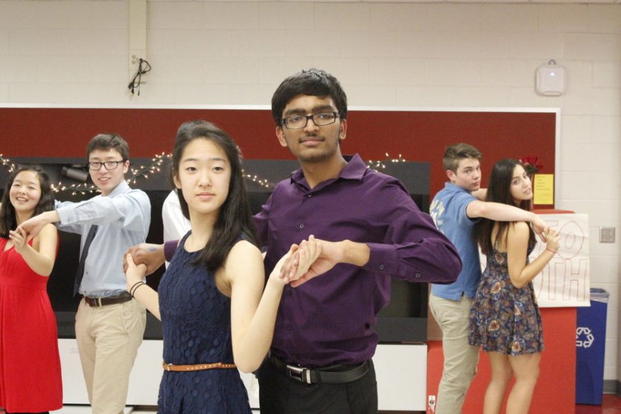 Sophomores Jainam Modh and Hannah Han hold a pose, as instructed by the dance teacher.