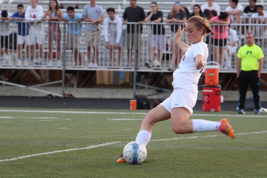 Senior Maaike Blindenbach kicks the ball during the girls varsity soccer game against Potomac Falls on May 24.