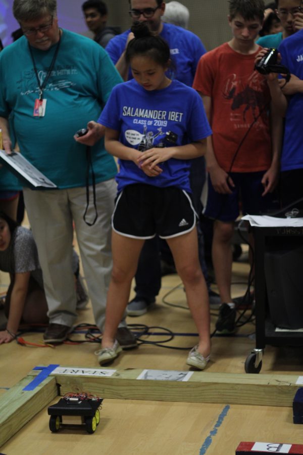 Kaitlin Phan watches her robot complete the obstacle course.