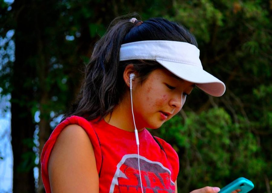 Rising junior Sophie Koh stares as her phone as she finds a Pokémon