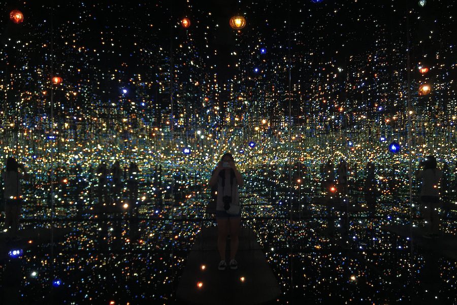 The+Infinity+Mirrored+Room+by+Yayoi+Kusama+is+currently+at+the+Broad.+Visitors+individually+enjoy+the+installation.