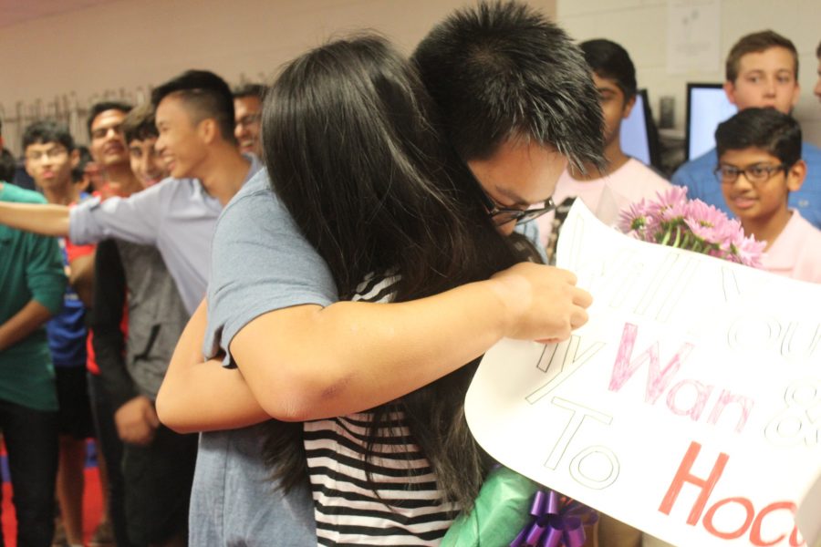 Sophomore Maxwell Lee hugs sophomore Wan Li after asking her to homecoming to the tune of 