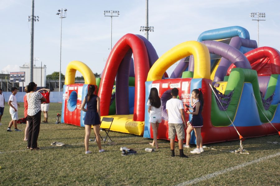 Students gather around the bounce house at the Back to School Bash, held on Sept. 9.