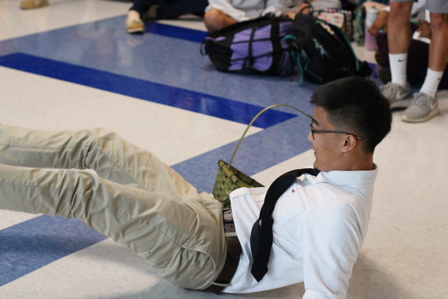 Senior Justin Lee acts in his skit before asking senior Laura Chu to homecoming. In the skit, Lee pretends to be late to his asking because he keep dropping his basket of limes, and is bad at pick up limes.