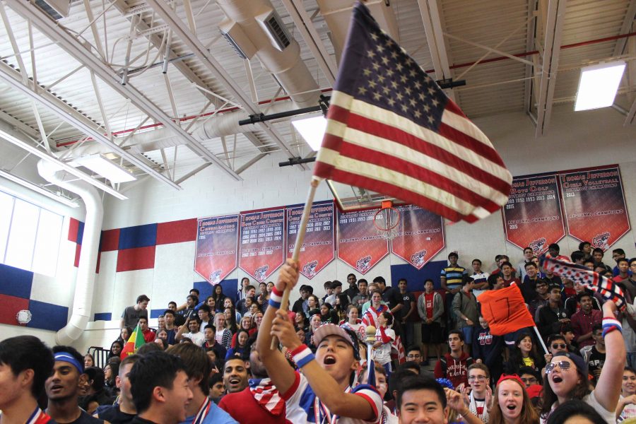 Senior Nick Yoon raises an American flag above members of the Class of 2017 to start off the pep rally during lunch on Tues., Oct. 11.