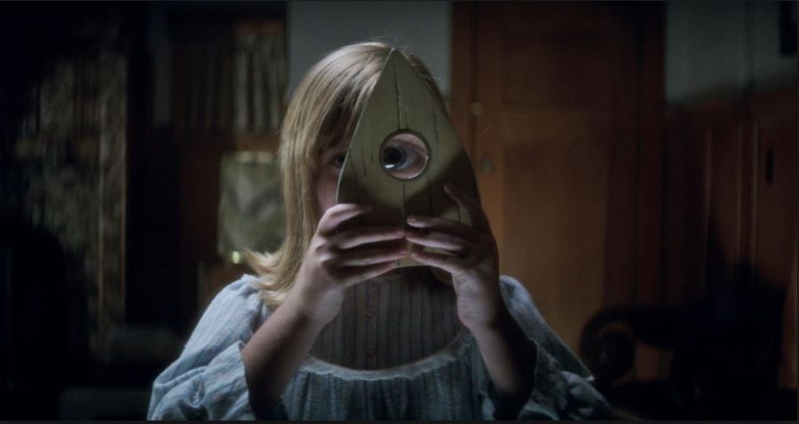 Photo courtesy of Universal Pictures. In this scene of the movie, Doris uses the planchette to try and see any spirit that may be trying to contact her through the Ouija board.