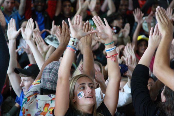 Senior Dana Scheetz raises her hands to show her class spirit.