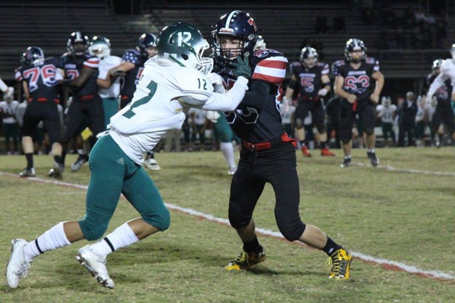 Wide receiver Kyle Gerner (right) blocks Falls Church defender Zayd Davis (left) as Jefferson runs the football