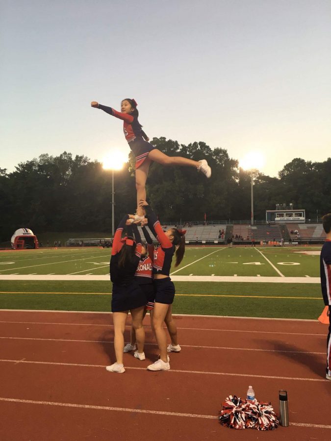 Senior Rachel Lee backspots a one-legged liberty at a football game.