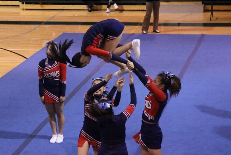 Rachel Lee backspots a flip at the cheerleading semifinals at Wakefield HS.