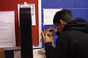 Science Olympiad team member Faaiz Memon perfects his Wind Turbine device in preparation for testing at the competition. By testing it now, he can modify and improve his design for future competitions. 