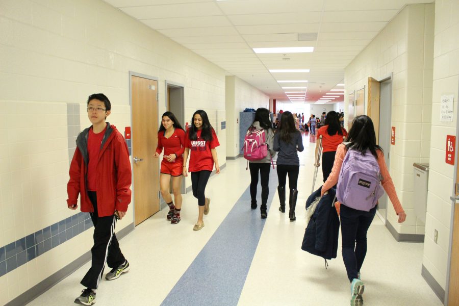 Students walk down the hall by the Freshman IBET commons on Red Day, in order to celebrate women’s rights.