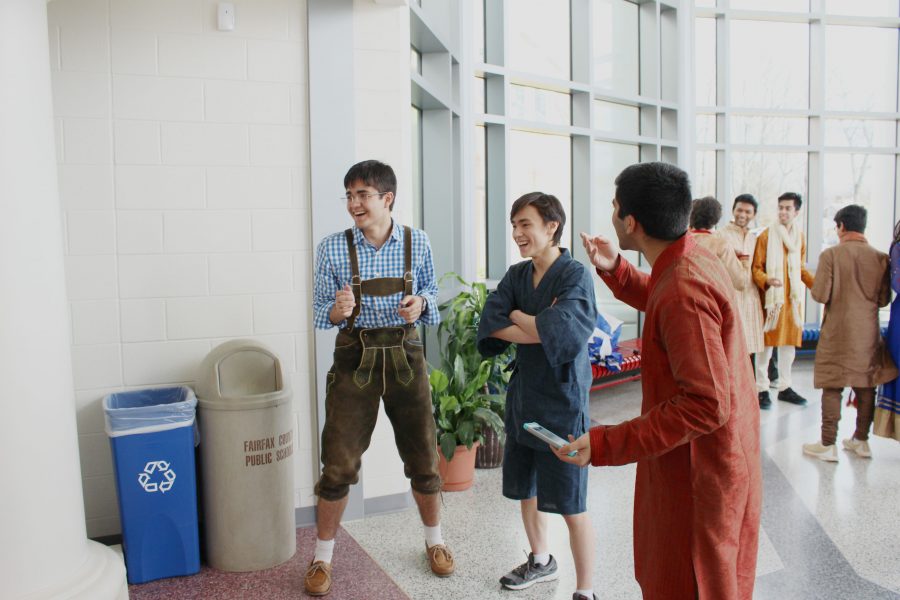 Juniors talk while waiting for friends to have their picture taken on International Day. From left to right, the juniors are wearing German, Japanese, and Indian clothes in order to represent their respective nationalities.