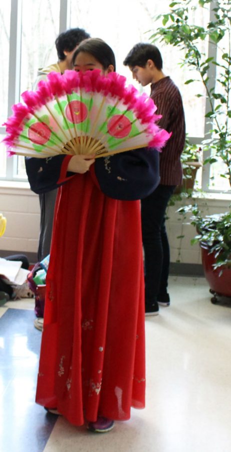 Junior Hannah Han fans her fan from Korean Culture Club for International Day.