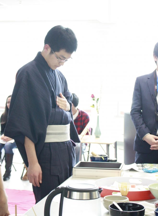 Japanese exchange student Hodaka Ishibashi adjusts his clothing before performing a tea ceremony.