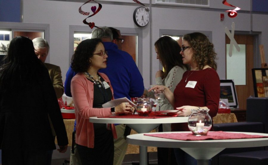 English teacher Suzette Henry converses with fellow English teacher Stephanie Glotfelty.