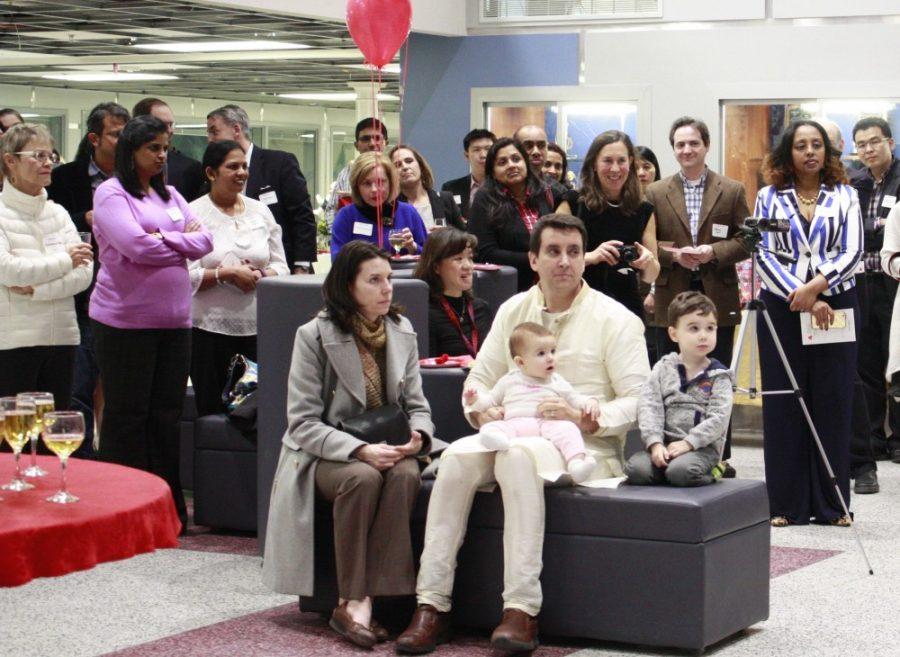 Parents and faculty listen to a speech.