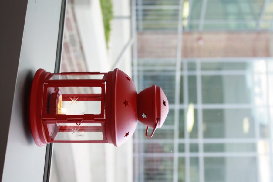 A lantern decorates a windowsill.