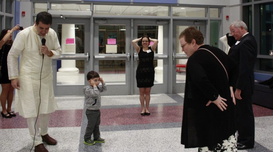 Parents play a game of heads and tails to win a two iNITE tickets.