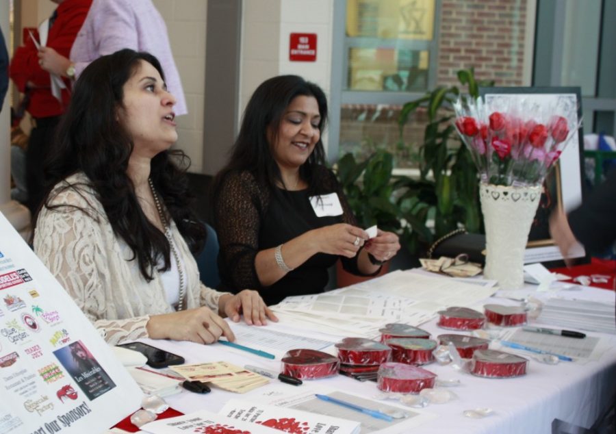 Volunteers check in parents and faculty attending the event.