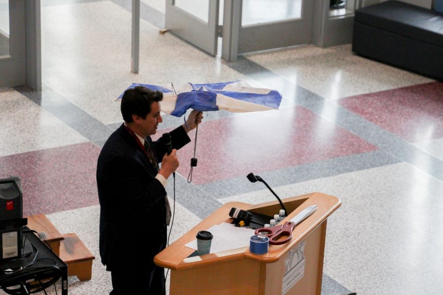 Photo courtesy of Angel Kim. Dr. Glazer holds up a broken umbrella during his speech.