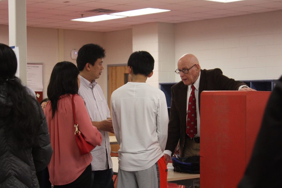 Computer Science teacher Stephen Rose answering questions from a rising freshman and their family