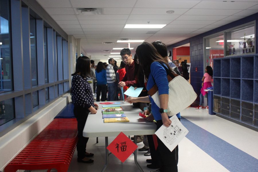 In the language hallway, Chinese teacher Qin Xu answers questions about the Chinese classes offered.