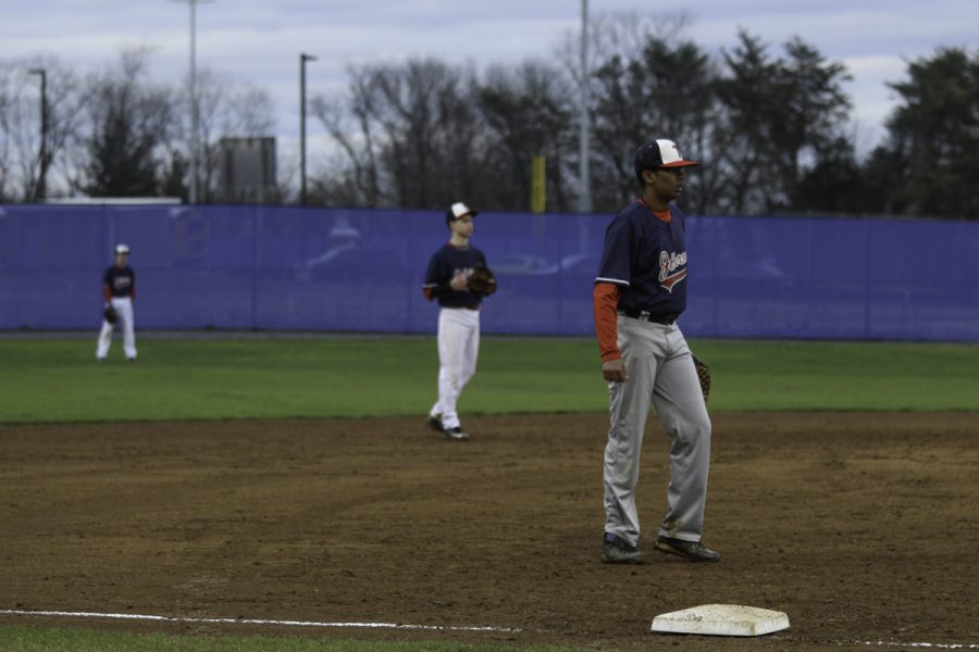 Players wait for the opposing batter to hit the ball.