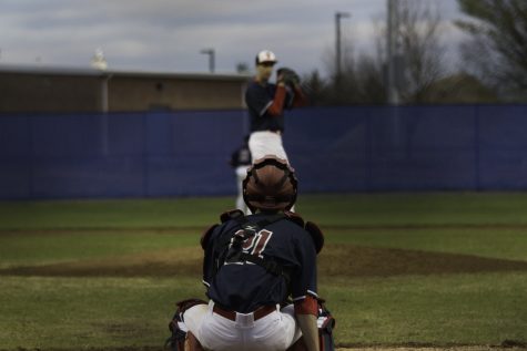 Freshman Patrick Zhang practices catching in between innings.