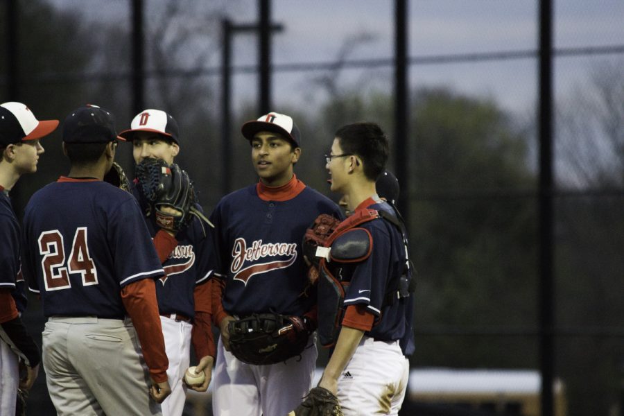 Players discuss game plans in between innings.