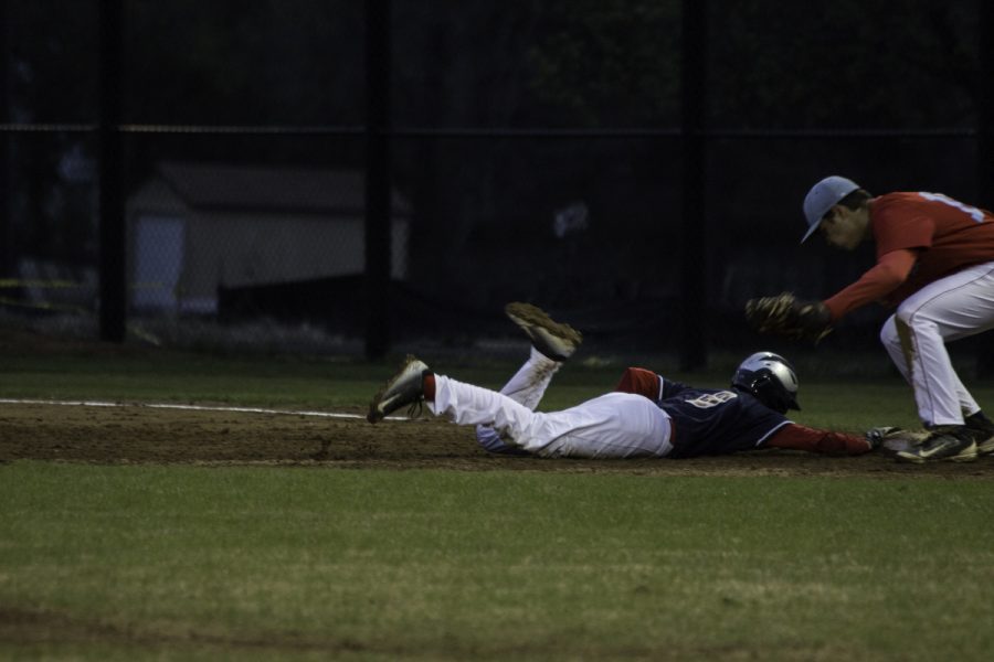 Freshman Andrew Arnold dives for the base.