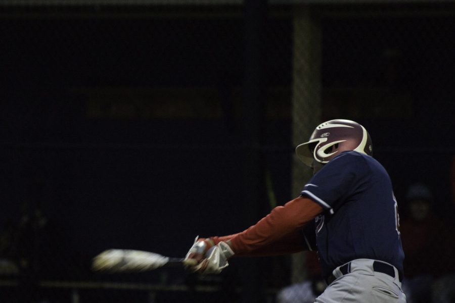 Sophomore Vikrant Magadi swings the bat.