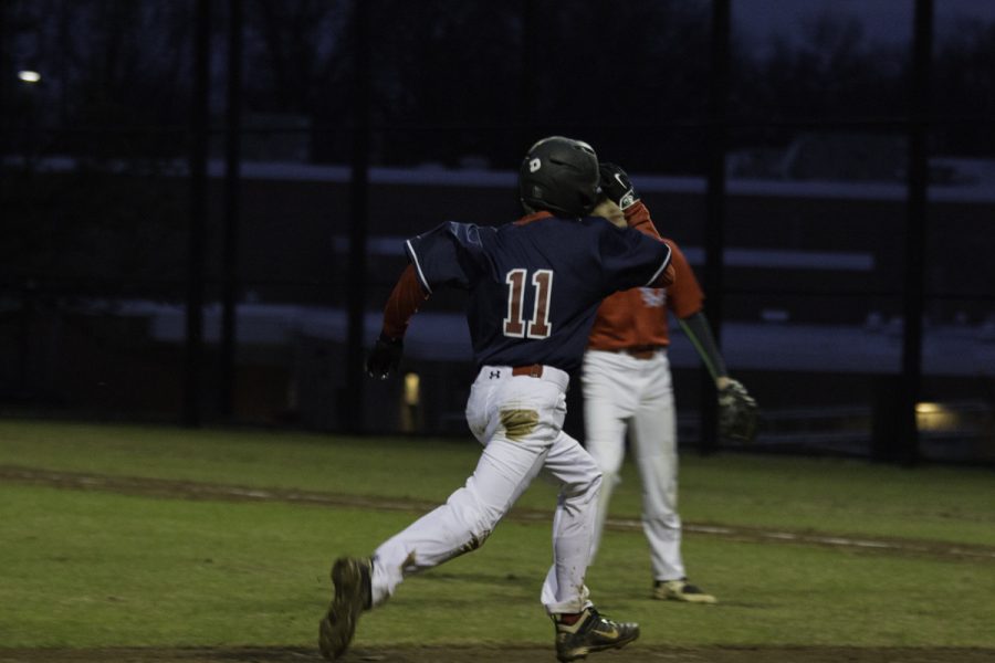 Freshman Charlie Dobson dashes toward home base.