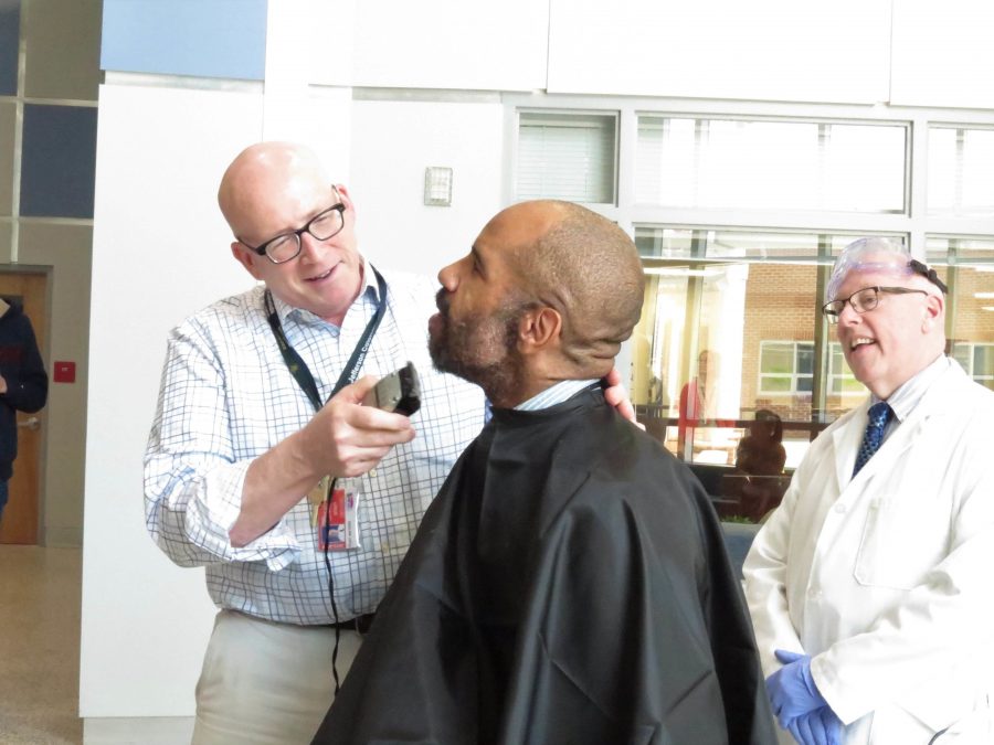 History teacher Kurt Waters shaves part of Franks beard while Grosicki watches.