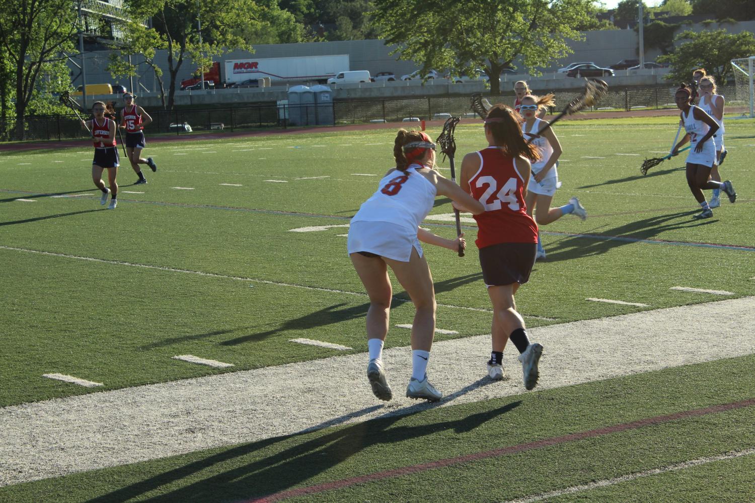 Marshall senior Rachel Piche guards Jefferson freshman Abby Kim as she runs with the ball toward the Marshall goal.