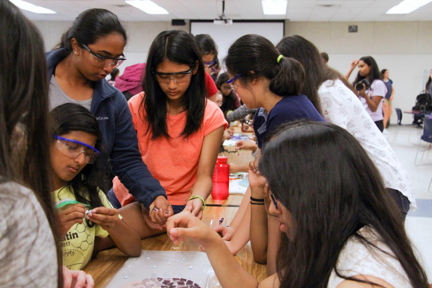 Students place tiles during an eighth period block open to the school on Apr. 28.